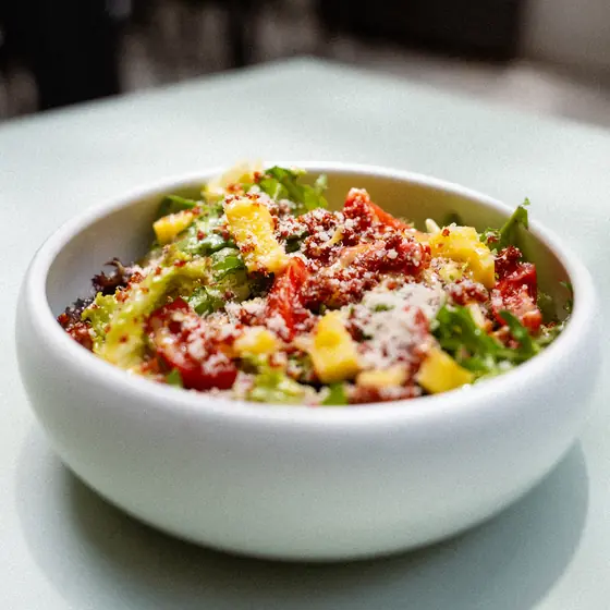 A quinoa salad with mango and cherry tomato